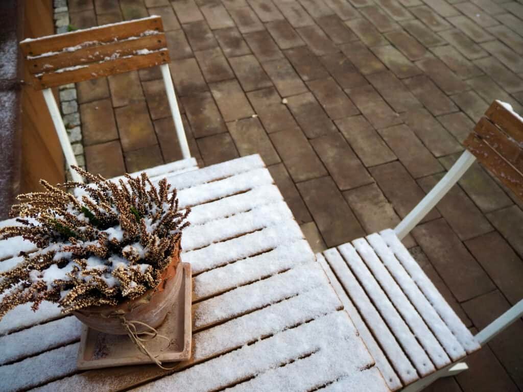 Schnee auf Holztisch